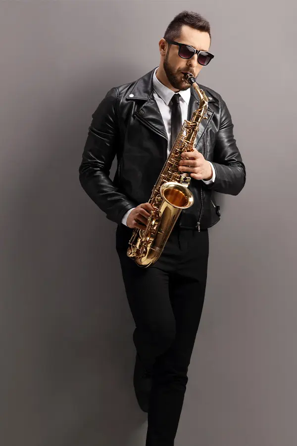 Man wearing leather jacket playing saxophone