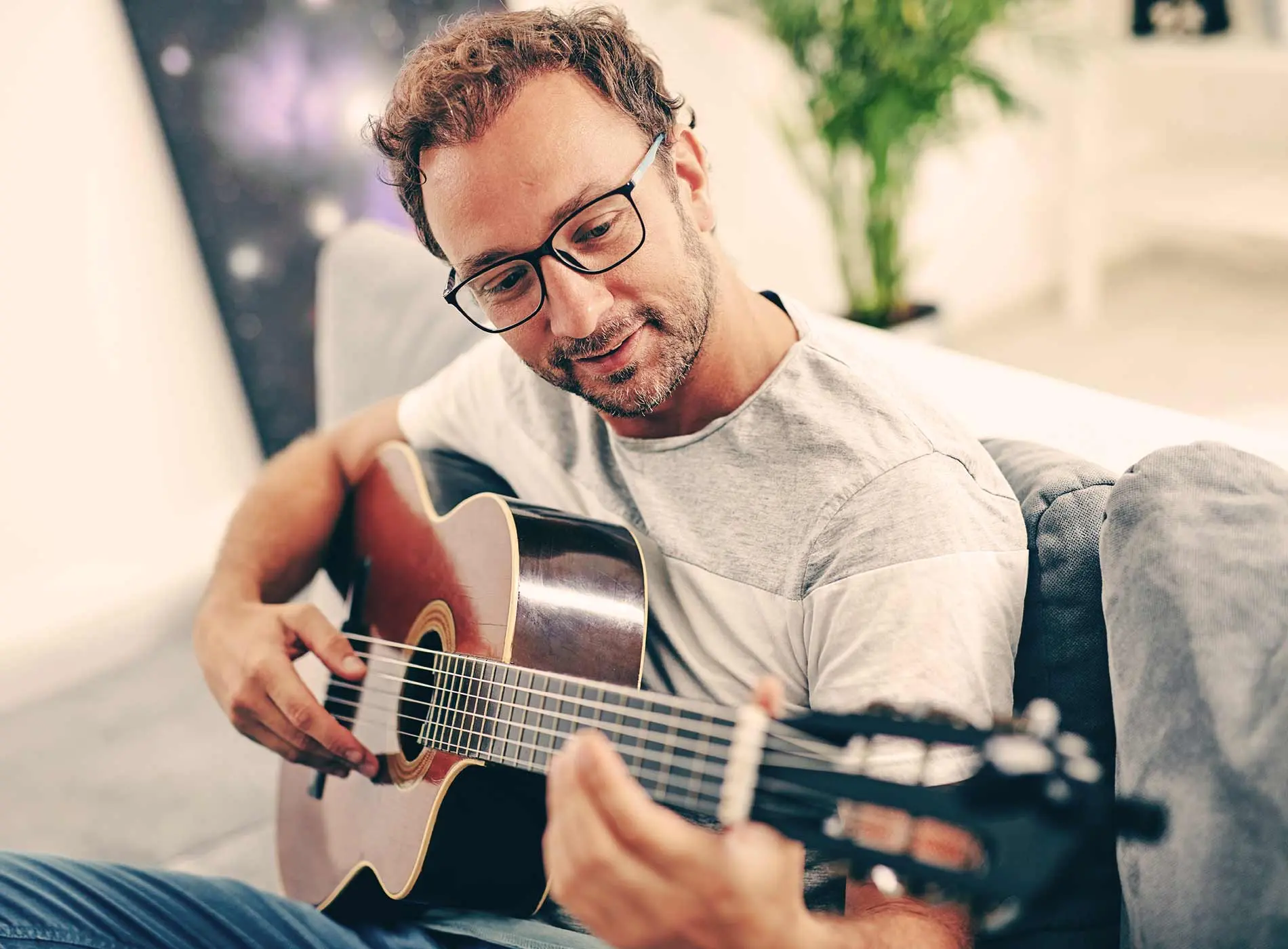 Man practicing guitar and enjoying the process
