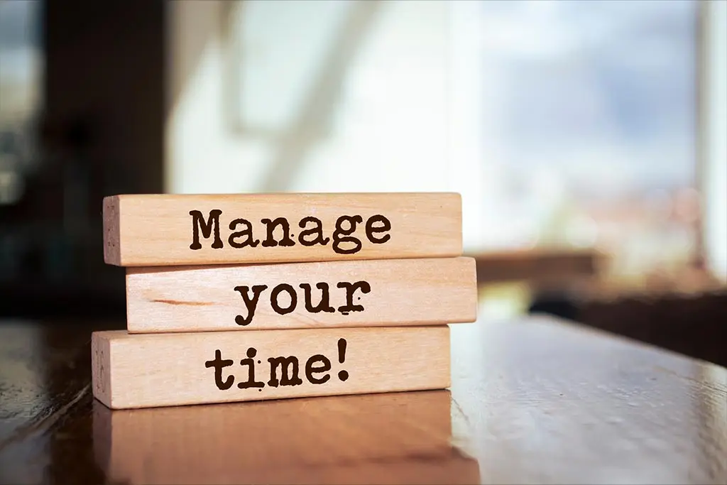 Wooden blocks spelling Manage your time on a table