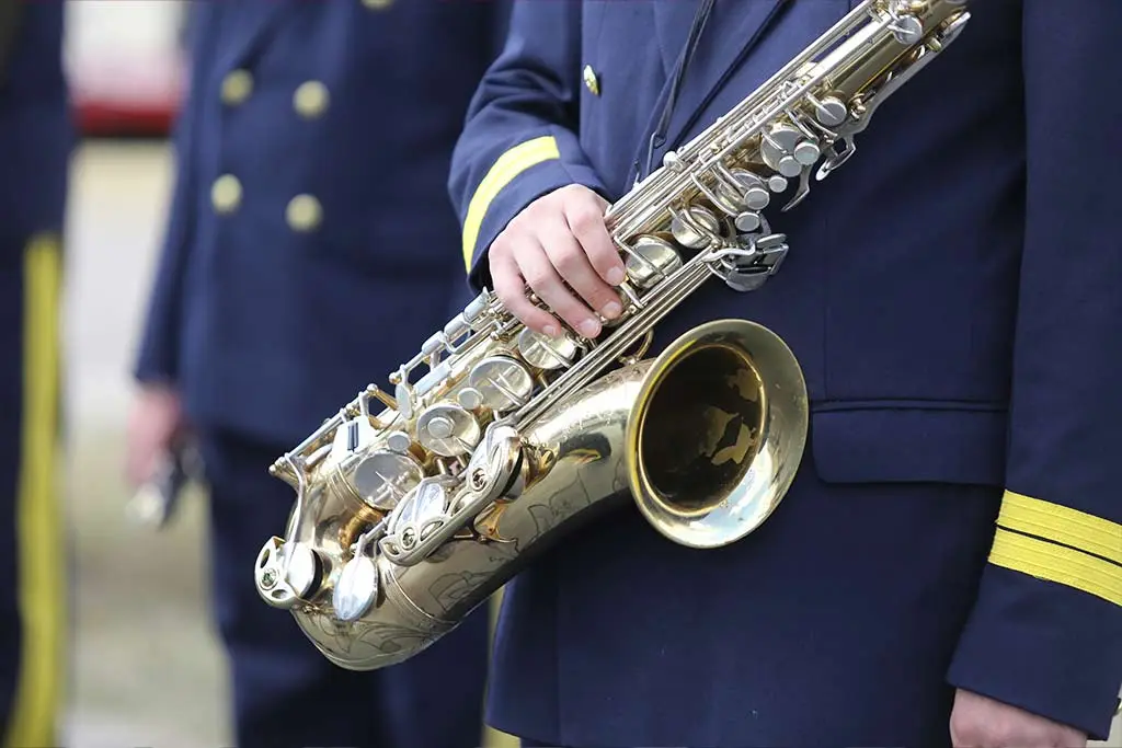 Military man holding a saxophone