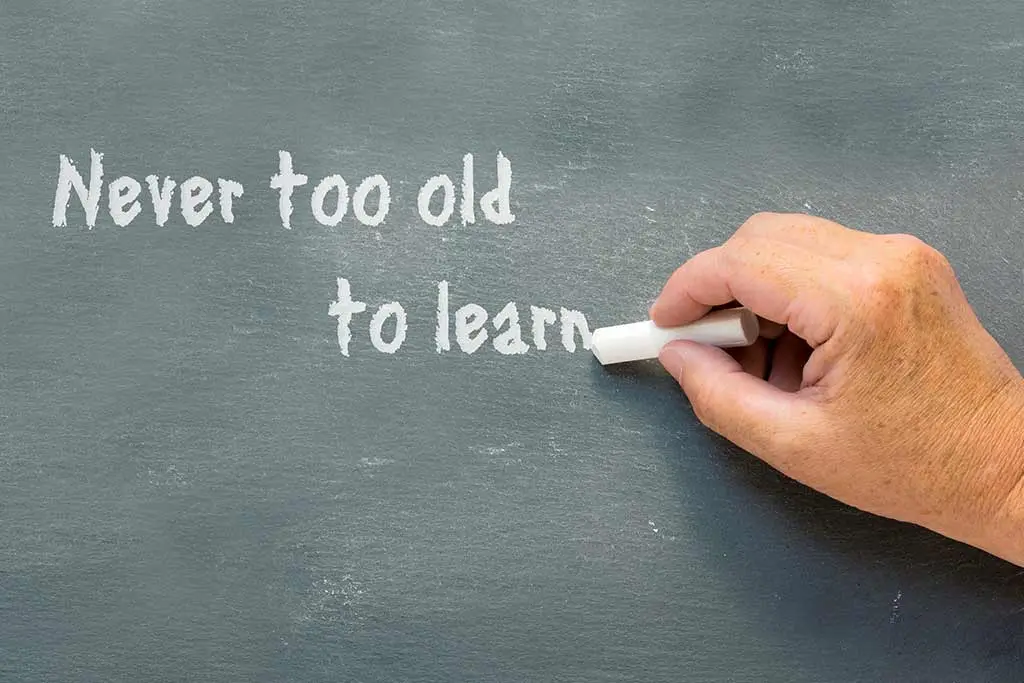Hand writing Never too old to learn on a chalkboard