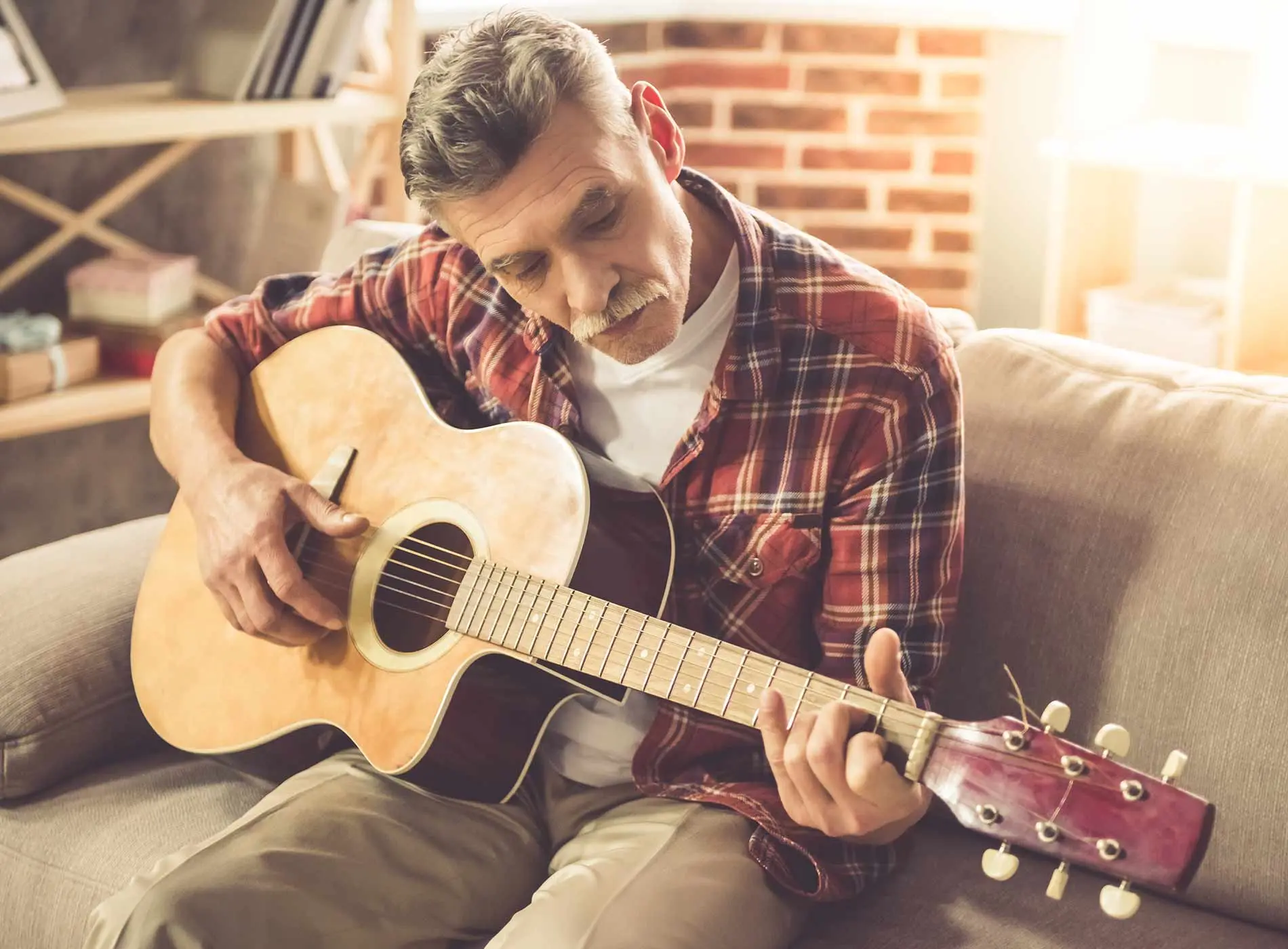 Older man playing the guitar