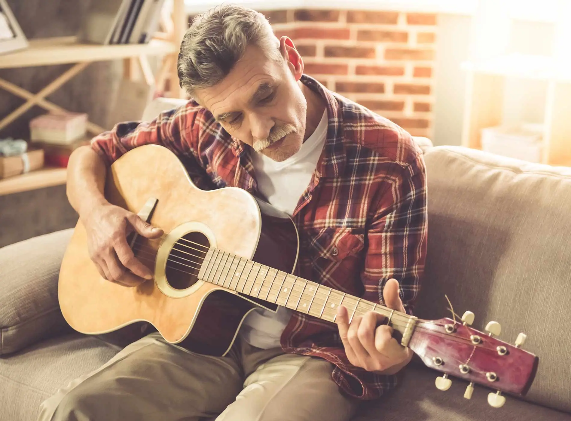 Older man playing the guitar
