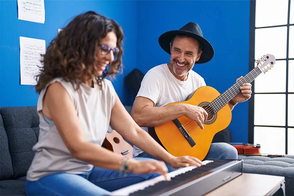 Pianist and guitarist playing together in studio