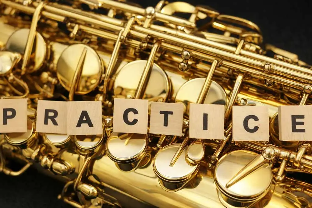 Letter tiles spelling practice on saxophone keys