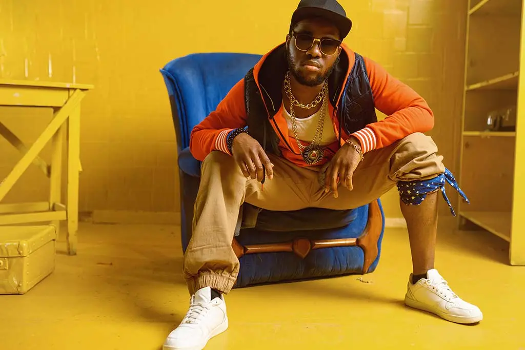 Image of rapper posing in chair