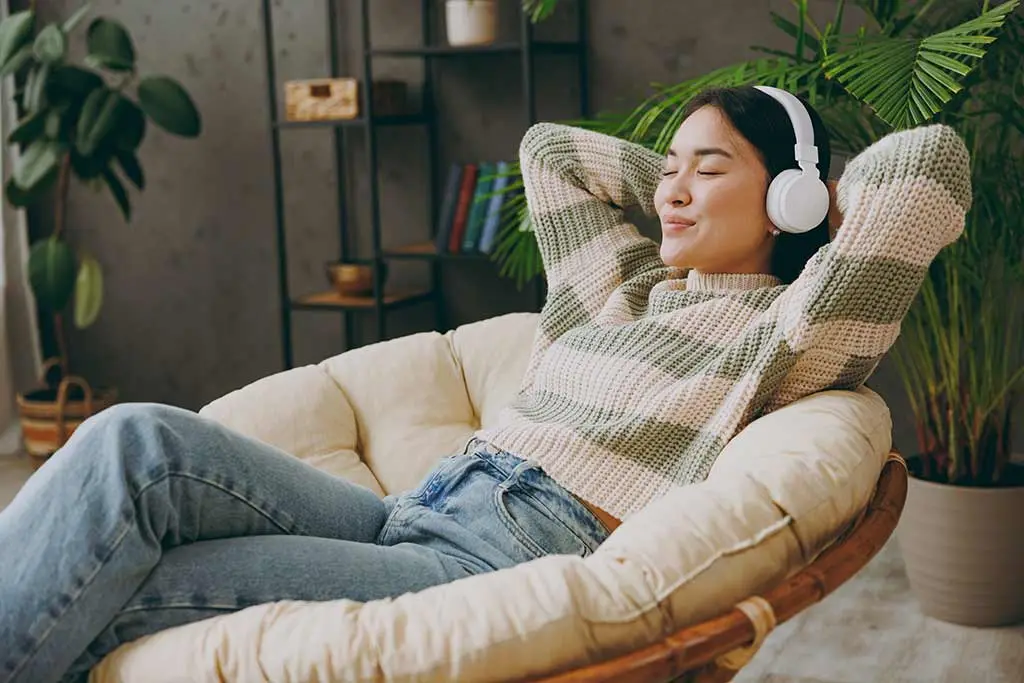 Relaxed woman sitting listening to music