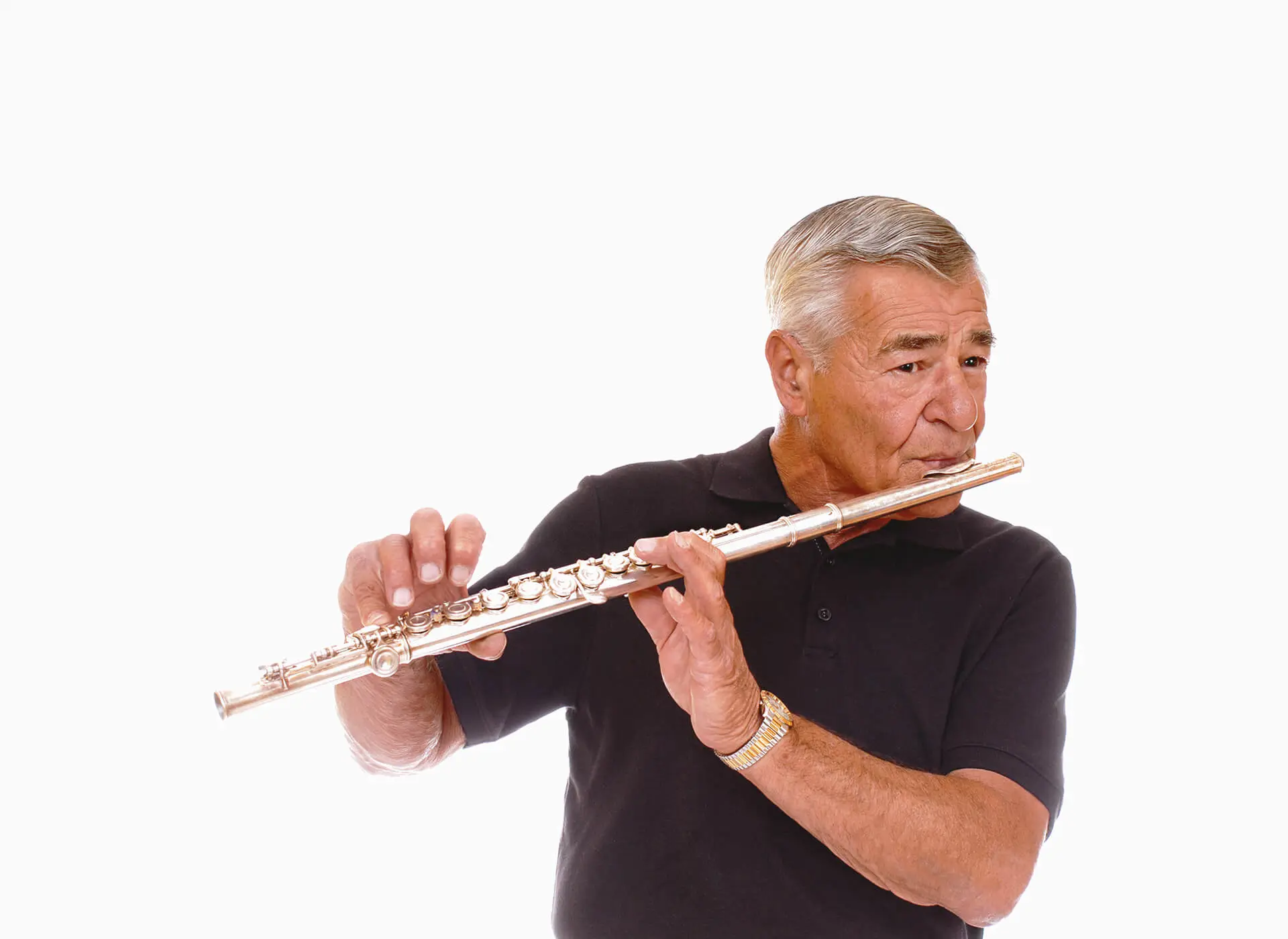Senior man playing a silver flute