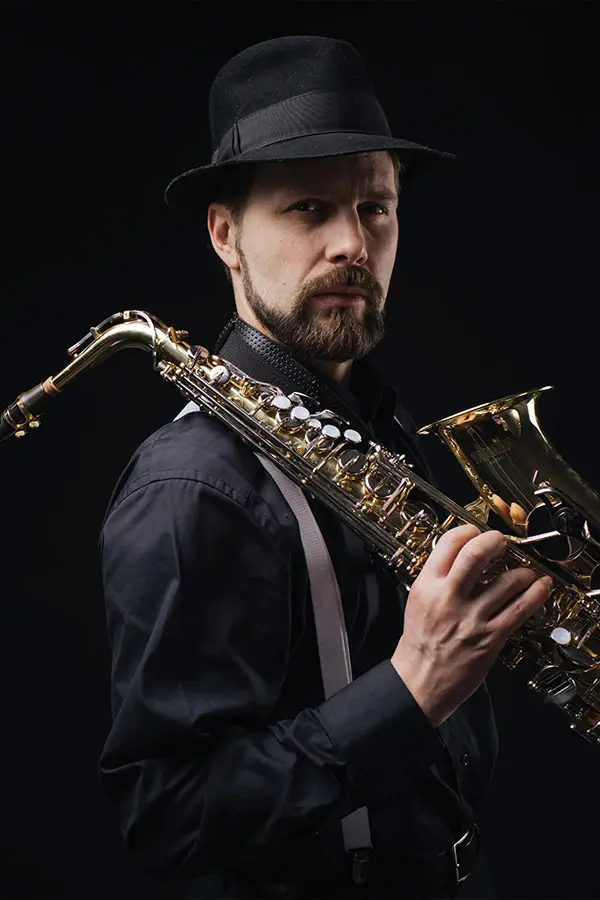 Serious man holding a saxophone