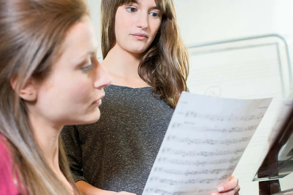 Singing teacher and student having lesson