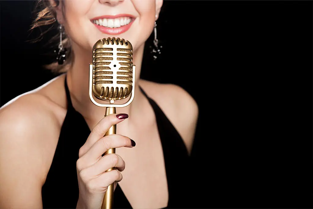 Smiling woman holding a retro microphone