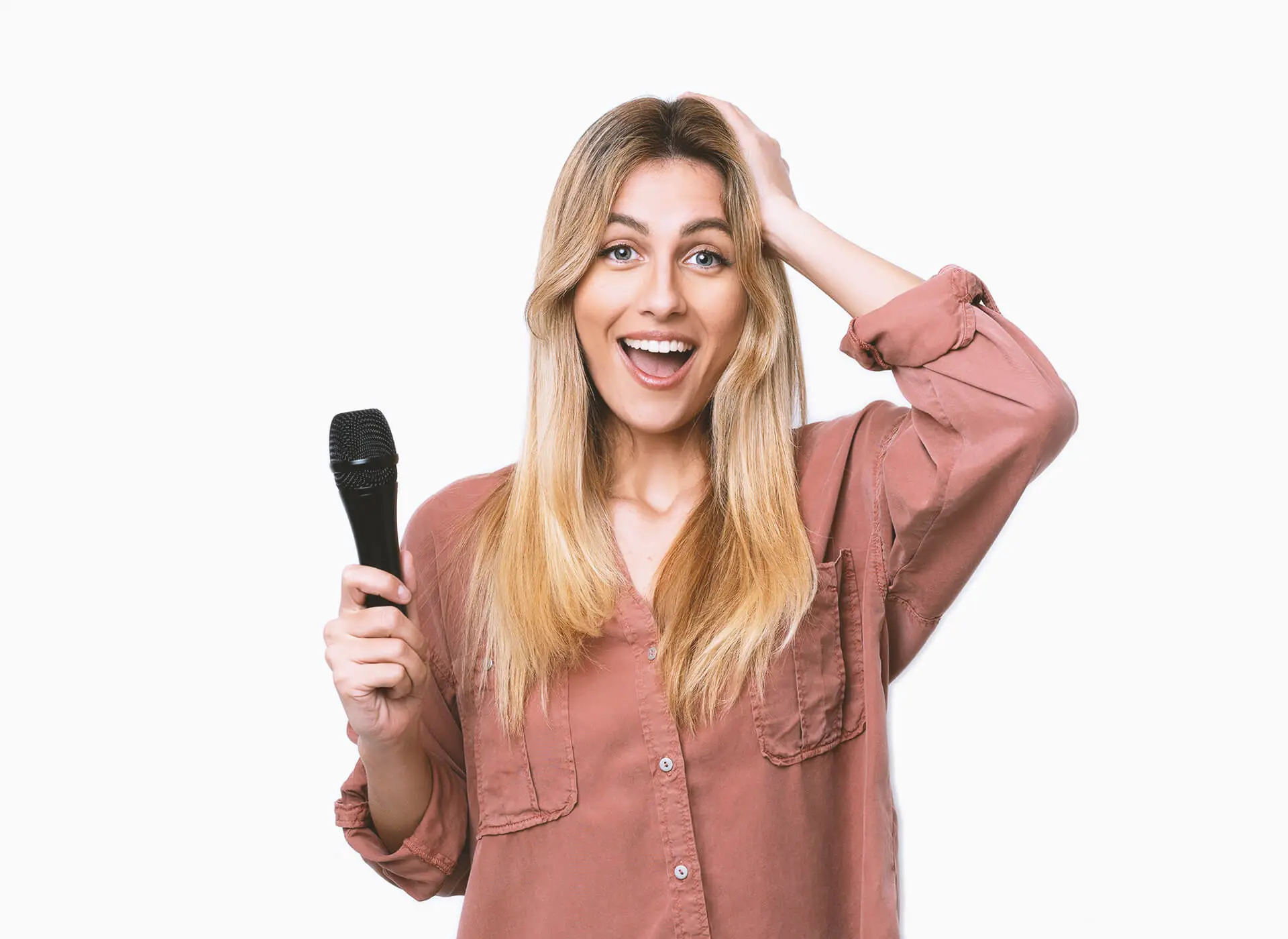 Surprised woman holding a handheld microphone and smiling