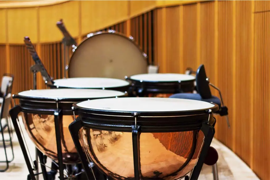 Timpani arranged in a wood-panelled room