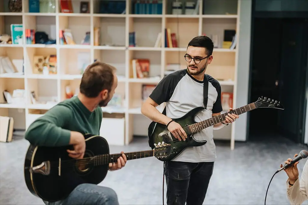 Two men playing guitar
