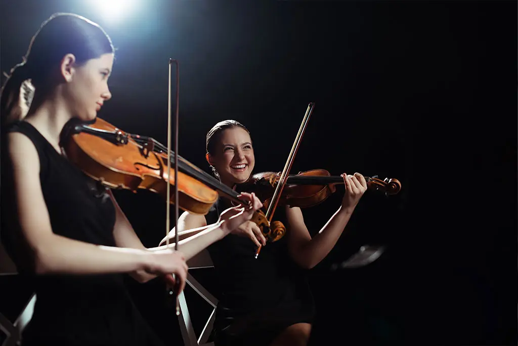Two violinists playing together