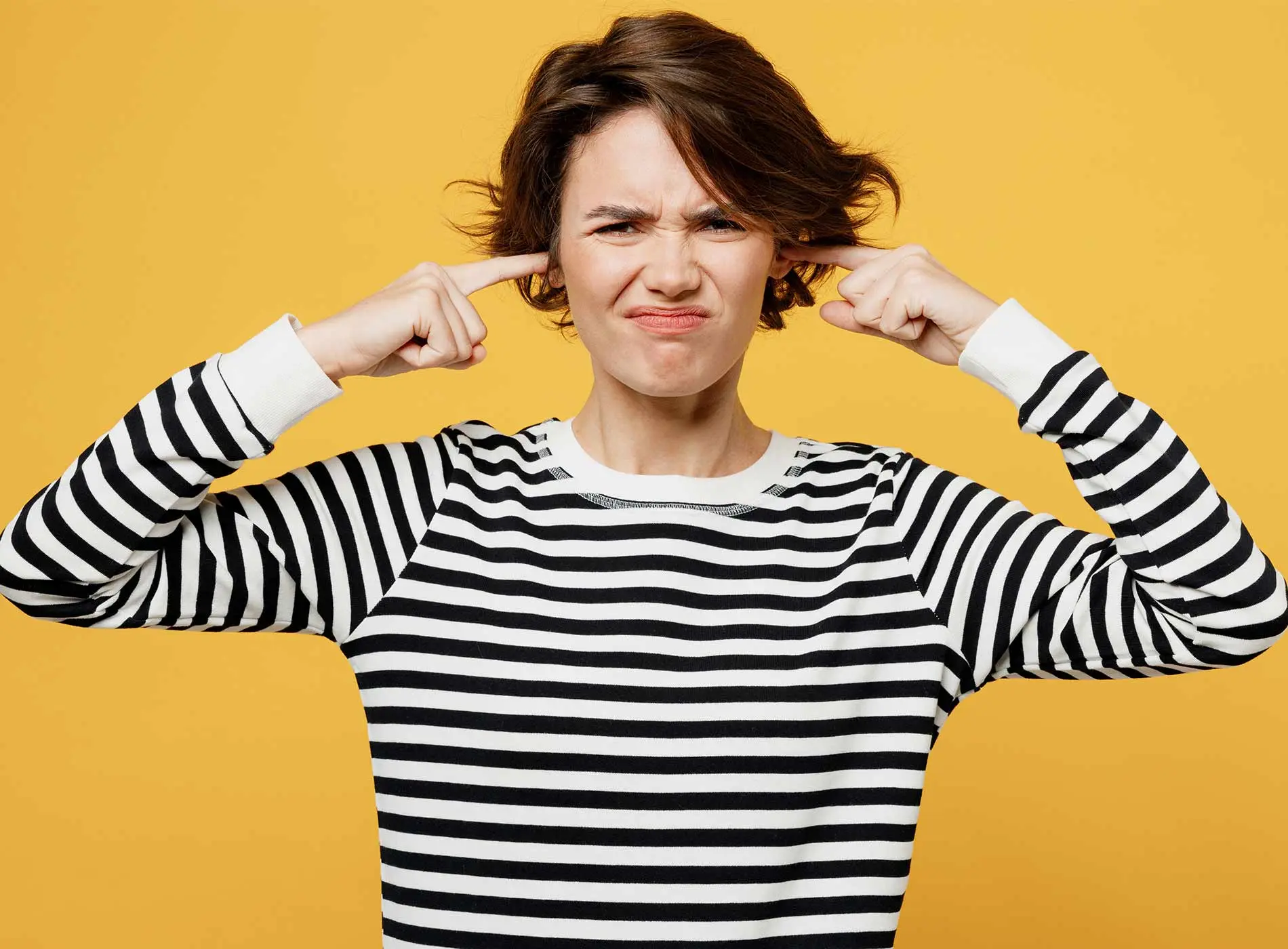 Woman covering her ears