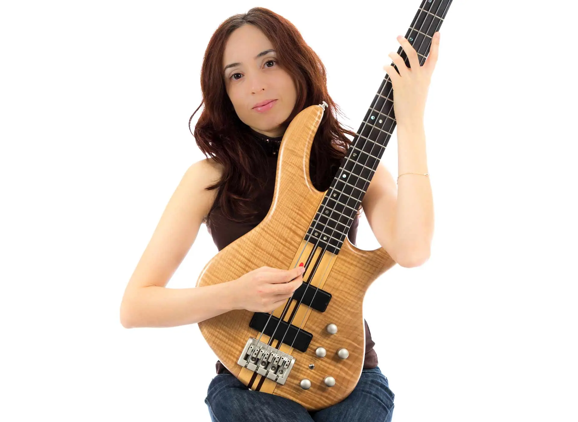 Woman holding an electric bass guitar against a white background
