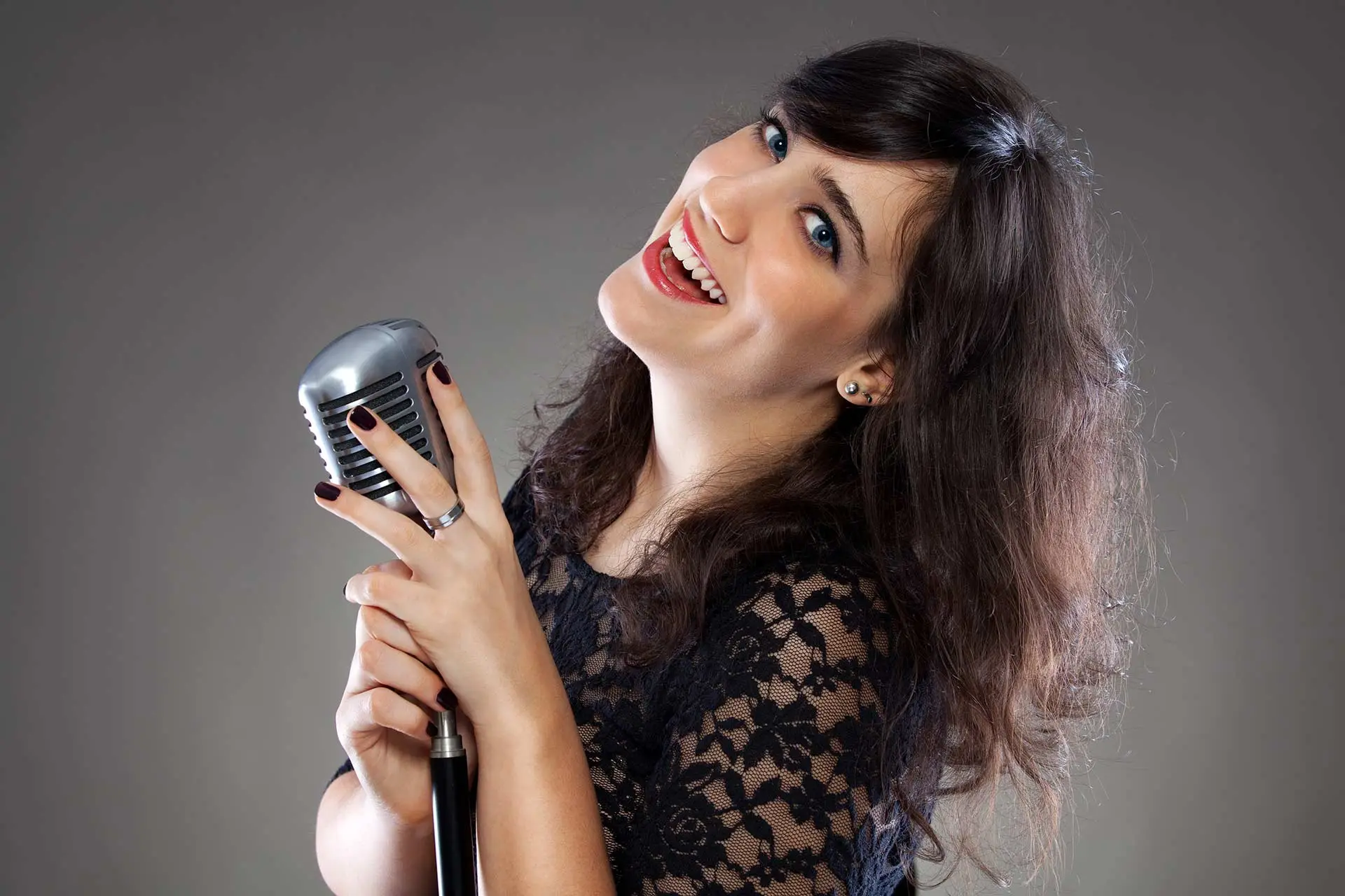 Smiling woman holding a retro microphone