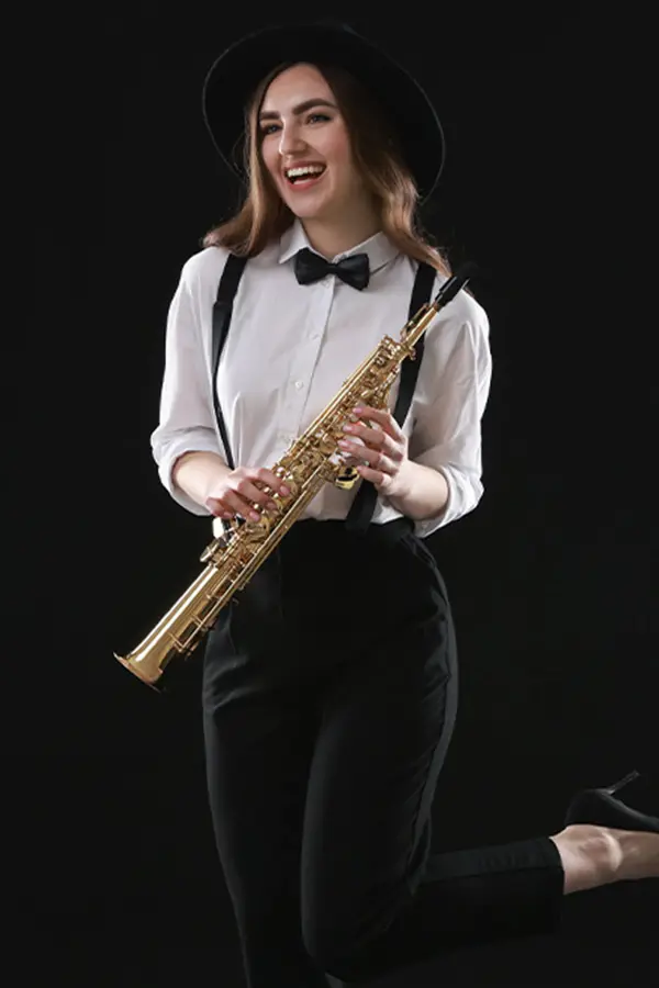Woman in a black hat holding a soprano saxophone