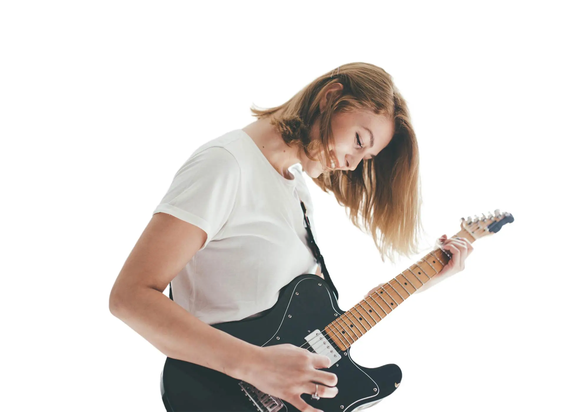 Woman in a white shirt playing a black electric guitar