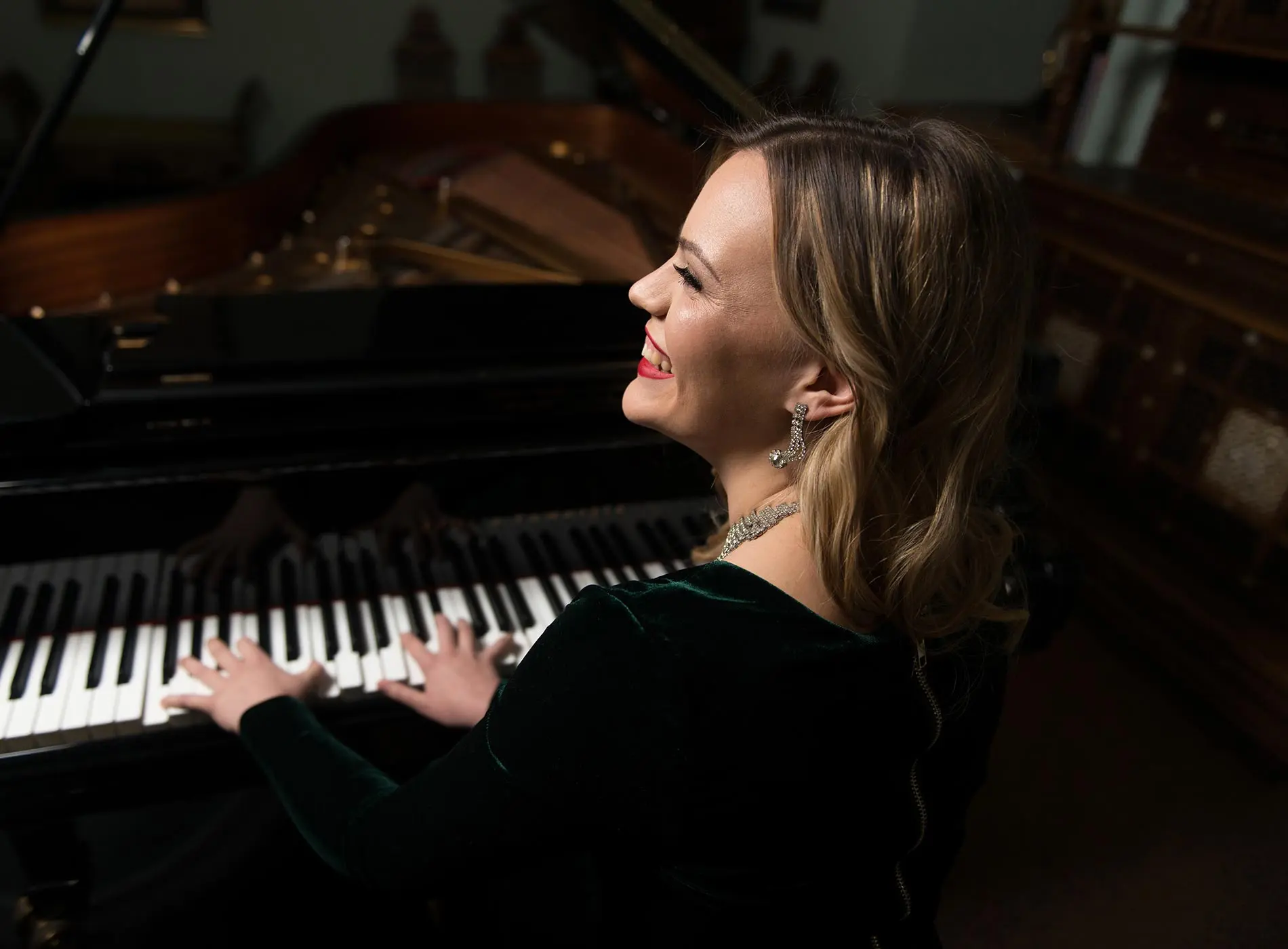 Lady smiling at the grand piano