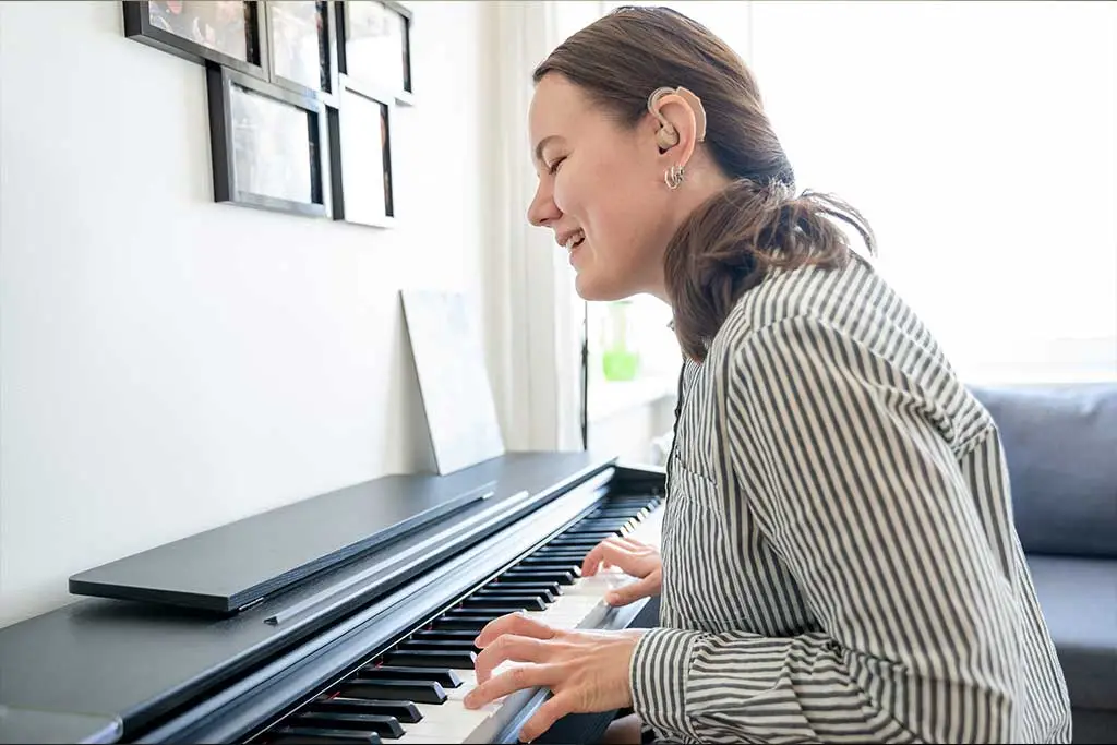 Woman playing piano at home