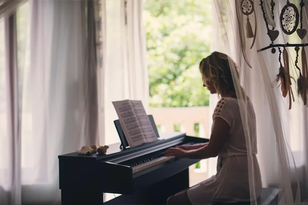 Woman playing piano at home