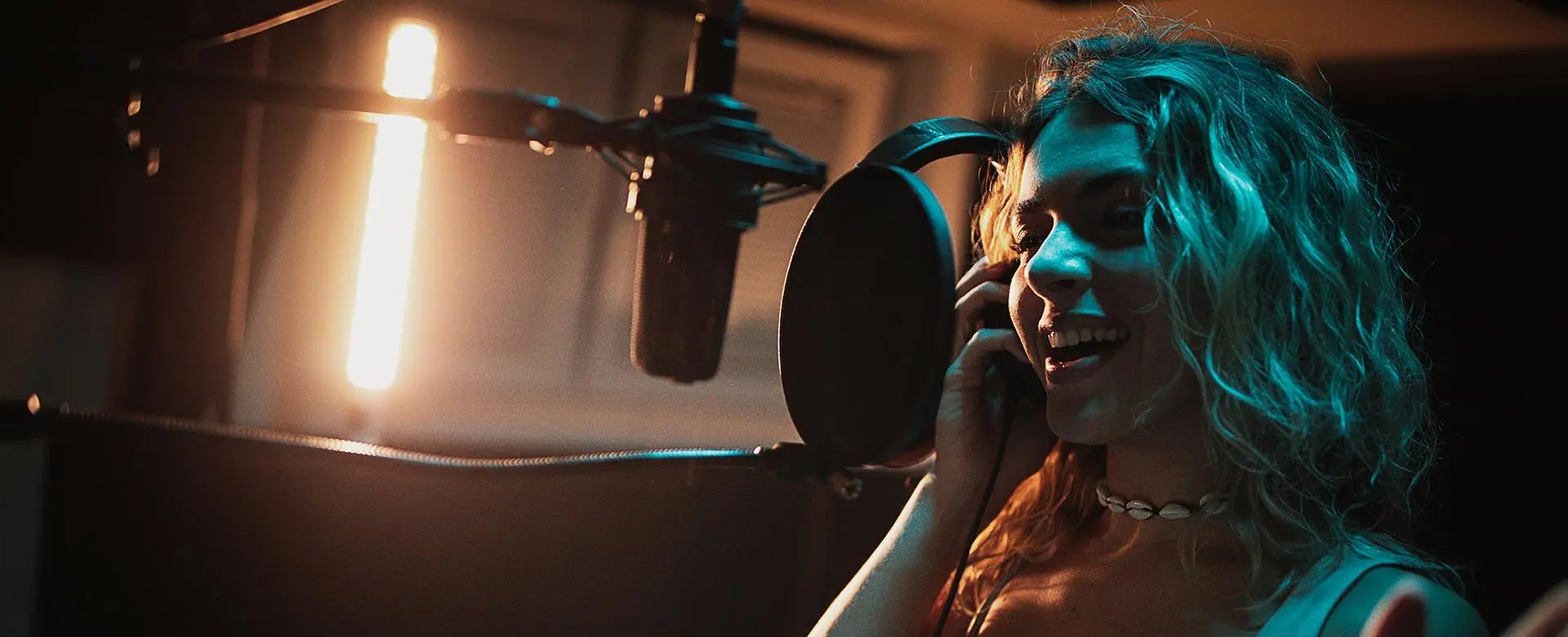 Lady singing in a studio in London
