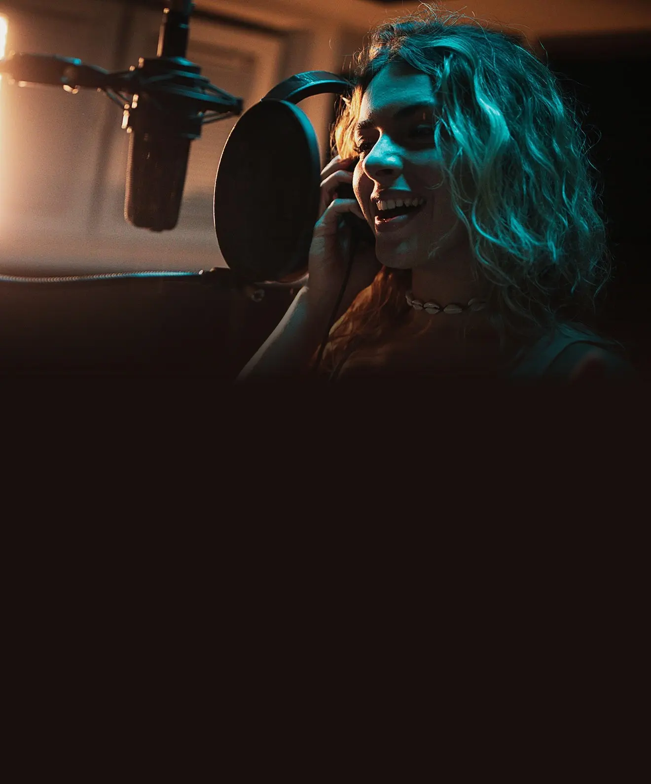 Lady singing in a studio in London