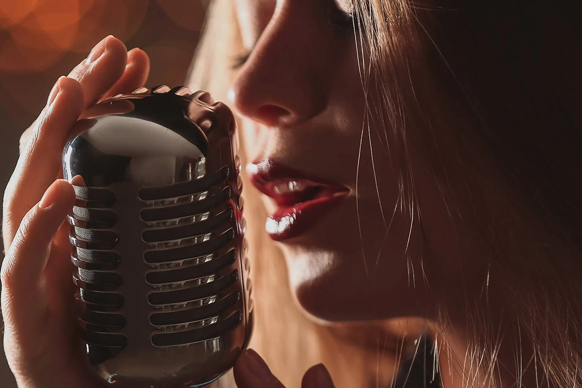 Woman singing using retro microphone