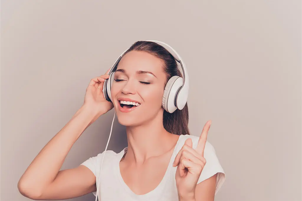 Woman singing while listening to music
