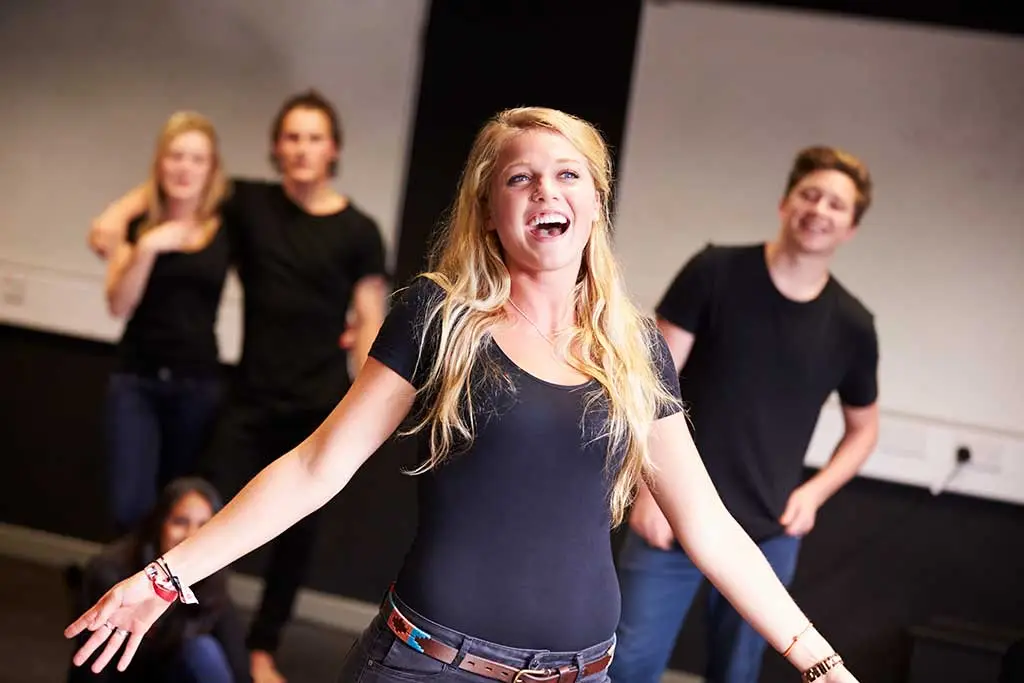 Woman singing in front of a small group