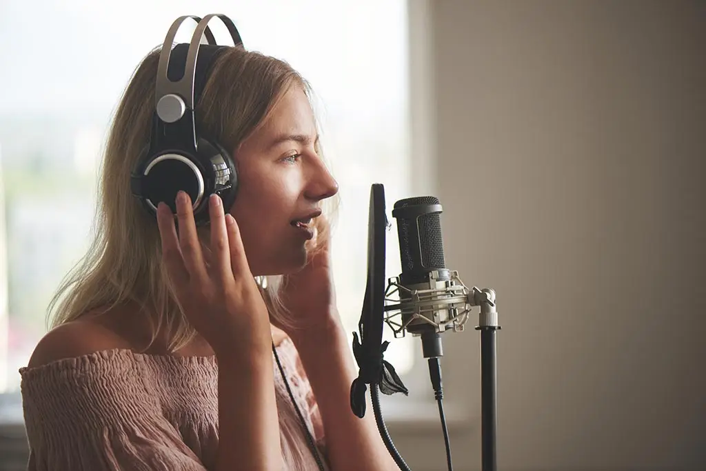 Woman wearing headphones singing