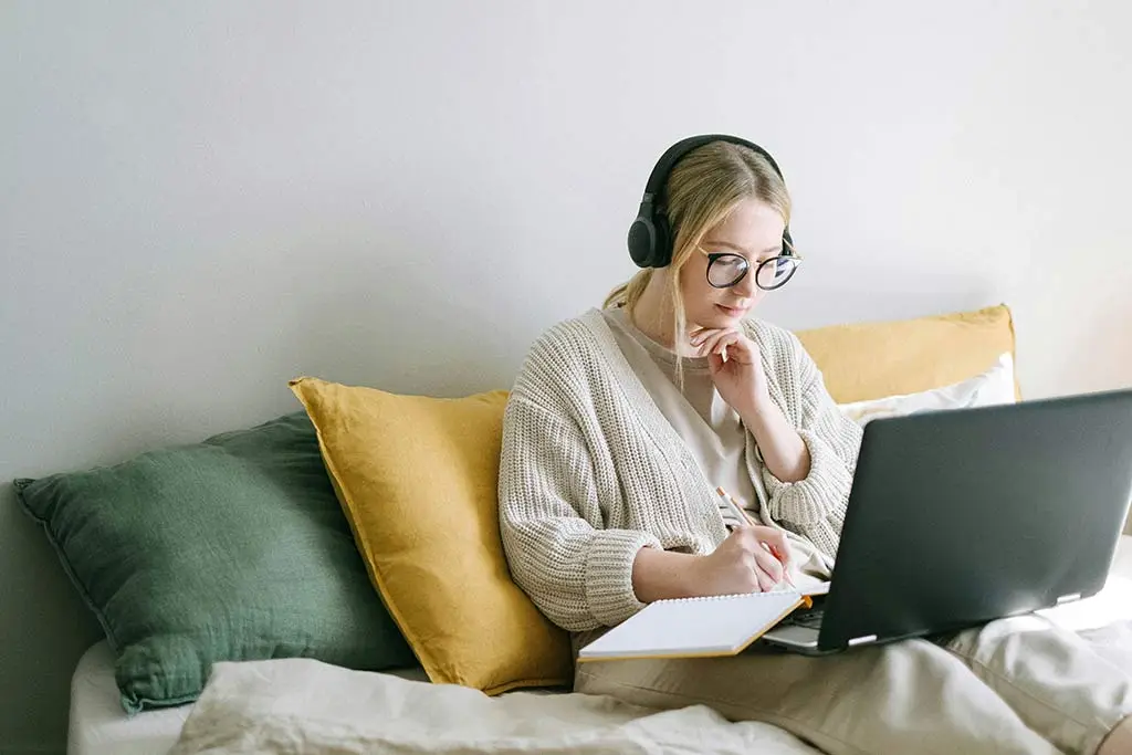Image of a woman working while listening to music