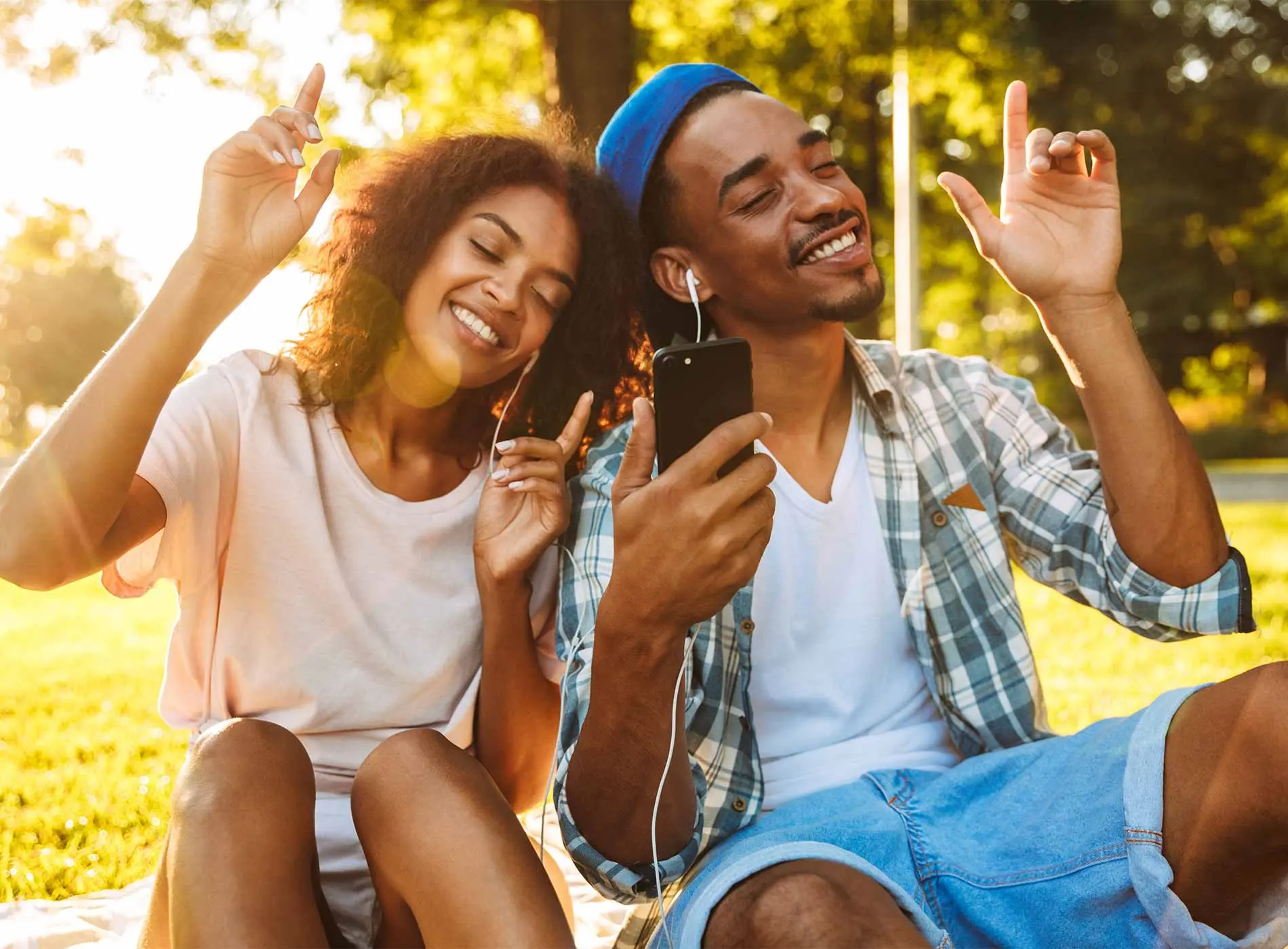 Two teenagers man and woman listening to music together