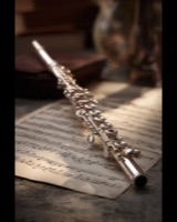 A silver flute lying on sheet music