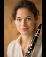 Smiling woman holding a clarinet