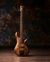 A wooden four-string bass guitar standing upright on a studio floor